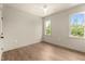Bedroom with hardwood floors, two windows, and natural lighting at 65 Stream View Way, Spring Hope, NC 27882