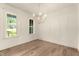 Bright dining room with hardwood floors, a traditional chandelier, and a window with a neighborhood view at 65 Stream View Way, Spring Hope, NC 27882