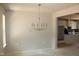 Elegant dining room with modern chandelier; kitchen visible in the background at 65 Stream View Way, Spring Hope, NC 27882