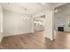 Spacious room showcasing hardwood floors, and an open floor plan leading to a fireplace and modern kitchen at 65 Stream View Way, Spring Hope, NC 27882