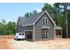 View of the home's exterior, featuring gray siding, white trim, and an attached garage at 65 Stream View Way, Spring Hope, NC 27882