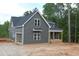A two-story new construction home features gray siding and an attached garage at 65 Stream View Way, Spring Hope, NC 27882