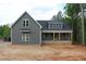 New construction home featuring gray siding, white framed windows, and a covered front porch at 65 Stream View Way, Spring Hope, NC 27882