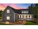 Charming two-story home showcasing its inviting front porch and meticulously landscaped front yard at 65 Stream View Way, Spring Hope, NC 27882