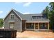 New home with gray siding, stone accents, and a covered front porch featuring wooden pillars at 65 Stream View Way, Spring Hope, NC 27882
