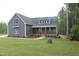 Beautiful exterior view with gray siding, a welcoming porch, and a well-manicured lawn at 65 Stream View Way, Spring Hope, NC 27882