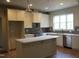 Bright kitchen featuring an island, stainless steel appliances, and stylish cabinetry at 65 Stream View Way, Spring Hope, NC 27882