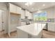 Bright kitchen with white cabinets, stainless appliances, an island, and neutral backsplash tile at 65 Stream View Way, Spring Hope, NC 27882