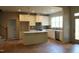 Open kitchen with a center island, stainless steel appliances, and light hardwood floors at 65 Stream View Way, Spring Hope, NC 27882
