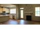 Open-concept room with a view of the kitchen and a fireplace with a decorative mantel at 65 Stream View Way, Spring Hope, NC 27882