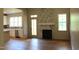 Spacious room featuring a fireplace, hardwood floors, and an open layout to the kitchen at 65 Stream View Way, Spring Hope, NC 27882