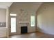 Bright living room with hardwood floors, a fireplace, and a door to the outside deck at 65 Stream View Way, Spring Hope, NC 27882