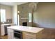 Open-concept layout featuring a kitchen island and a decorative fireplace with white mantel at 65 Stream View Way, Spring Hope, NC 27882