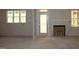 Open-concept living room featuring windows, a door to a porch, and a fireplace at 65 Stream View Way, Spring Hope, NC 27882