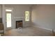 Spacious living room with a fireplace and access to a porch through a glass door at 65 Stream View Way, Spring Hope, NC 27882