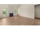 Living room featuring a fireplace with marble surround, access to porch, hardwood floors, and natural light at 65 Stream View Way, Spring Hope, NC 27882