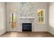 Elegant living room with marble fireplace, a door to an outdoor deck, hardwood floors, and natural light at 65 Stream View Way, Spring Hope, NC 27882