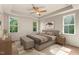 Serene primary bedroom with tray ceiling, neutral tones, and windows providing natural light at 65 Stream View Way, Spring Hope, NC 27882