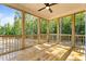 Screened in porch area with wood flooring and forest views at 65 Stream View Way, Spring Hope, NC 27882