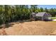 Rear exterior of home showing large yard, deck, and dark gray siding at 65 Stream View Way, Spring Hope, NC 27882