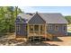 Home back exterior with a wooden deck and a dark gray siding at 65 Stream View Way, Spring Hope, NC 27882