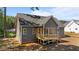 Home back exterior with a wooden deck and a dark gray siding at 65 Stream View Way, Spring Hope, NC 27882