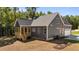 Home back exterior with a wooden deck, a dark gray siding and a 2-car garage at 65 Stream View Way, Spring Hope, NC 27882