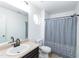 Clean bathroom featuring a vanity with white sink, a large mirror, and a shower with a decorative curtain at 6808 Lakinsville Ln, Raleigh, NC 27610