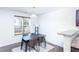 Modern dining area featuring a sleek black table and chairs with natural light from the window at 6808 Lakinsville Ln, Raleigh, NC 27610