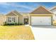 Charming single-story home with neutral siding, decorative shutters, and an attached two-car garage at 6808 Lakinsville Ln, Raleigh, NC 27610