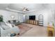 Inviting living room featuring a tray ceiling, neutral paint, and stylish furnishings with a ceiling fan at 6808 Lakinsville Ln, Raleigh, NC 27610