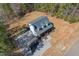 An aerial view of the home surrounded by a gravel driveway and grassy lawn at 692 Port Dr, Henderson, NC 27537