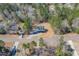 Aerial view showcasing the home's setting amongst trees and neighboring houses in the community at 692 Port Dr, Henderson, NC 27537