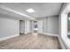 Spacious unfinished basement with gray walls and faux wood flooring, leading to an open doorway at 692 Port Dr, Henderson, NC 27537