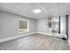 A clean unfinished basement with gray walls and floors, showcasing a bright window and mechanicals at 692 Port Dr, Henderson, NC 27537