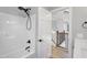Clean, neutral bathroom featuring a tub and shower combination and an open doorway to the second floor at 692 Port Dr, Henderson, NC 27537