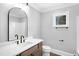 Clean bathroom with a modern sink, neutral gray walls, and a framed window at 692 Port Dr, Henderson, NC 27537