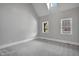 Bright bedroom featuring soft carpet, high ceilings, and natural light from multiple windows at 692 Port Dr, Henderson, NC 27537