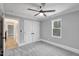 Cozy bedroom featuring gray walls, plush carpet, and a ceiling fan with stylish light fixture at 692 Port Dr, Henderson, NC 27537