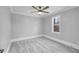 Neutral bedroom with soft gray carpet, ample natural light, and modern ceiling fan at 692 Port Dr, Henderson, NC 27537