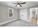 Neutral bedroom featuring soft gray carpet, a ceiling fan, and a double-door closet at 692 Port Dr, Henderson, NC 27537