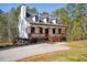Beautiful exterior elevation, showcasing a porch, a manicured lawn and a gravel driveway at 692 Port Dr, Henderson, NC 27537