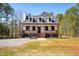 Charming two-story home with a inviting front porch and well-manicured landscaping at 692 Port Dr, Henderson, NC 27537
