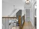 Hallway featuring hardwood floors, iron railing and views of the home's interior at 692 Port Dr, Henderson, NC 27537