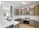 Well-equipped kitchen with grey cabinetry, quartz countertops, and stainless steel appliances at 692 Port Dr, Henderson, NC 27537