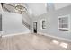 Bright living room featuring beautiful hardwood floors, staircase, and natural light from many windows at 692 Port Dr, Henderson, NC 27537