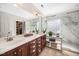 Bright bathroom with a double sink vanity, marble walk-in shower, and a large mirror at 706 Oldwyck Dr, Fuquay Varina, NC 27526