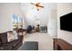 Open bedroom has a cozy brown couch, large TV, and natural light at 706 Oldwyck Dr, Fuquay Varina, NC 27526