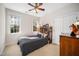 Comfortable bedroom with a full size bed, a ceiling fan, and natural light coming through the windows at 706 Oldwyck Dr, Fuquay Varina, NC 27526
