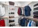 Organized walk-in closet with shelves and hanging rods for shoes, clothes, and accessories at 706 Oldwyck Dr, Fuquay Varina, NC 27526